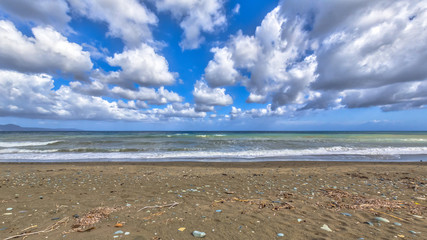 View of mediterranean beach with fluffy clouds