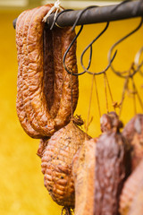 Smoked sausages meat hanging in smokehouse