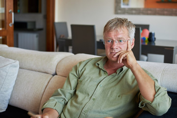 Middle-aged handsome man at home front of the camera