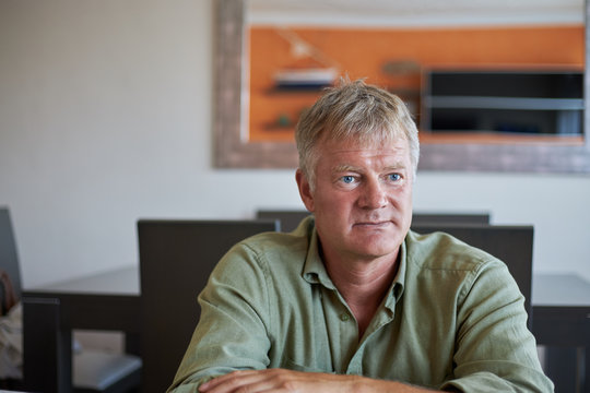 Middle-aged handsome man at home front of the camera