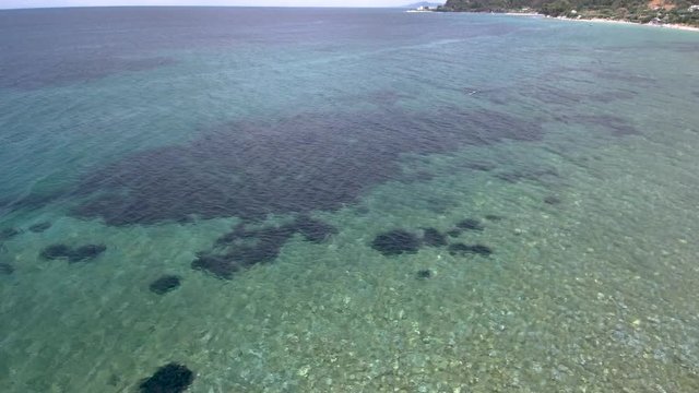 Aerial view of amazing  turquoise sea in the area of Agia Paraskevi Halkidiki, Greece, move forward by drone