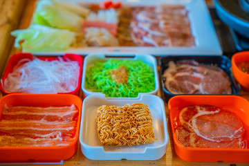 Shabu Shabu, a popular dish of pork, beef, shrimp, squid, seafood and fresh vegetables. Placed on a table with food set shabu shabu