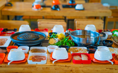 Shabu Shabu, a popular dish of pork, beef, shrimp, squid, seafood and fresh vegetables. Placed on a table with food set shabu shabu
