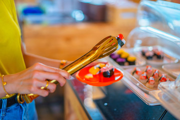 A young beautiful asian girl eating sushi with relaxing time food time of a Japanese restaurant
