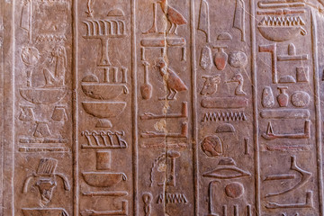 Egyptian ancient hieroglyphs on the stone wall in a temple of Hatshepsut