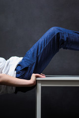 human body sits on a white table photo