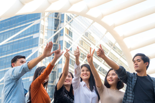 Energetic Optimistic Teen People Show Hand Up With Many Symbol Of Thump Up,victory,mini Heart And Looking Forward Standing With Confidence At Outdoor Space City.