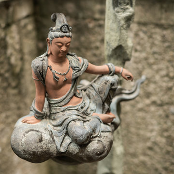 stone statue of bodhisattva sit on a cloud