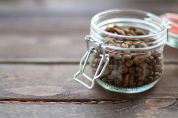jar of coffee beans and a wooden table