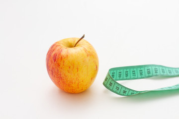 apple with measuring tape isolated on white