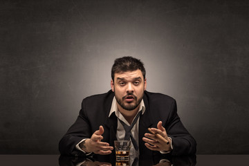 Young drunk man at his office with free dark copyspace
