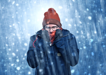 Handsome young boy shivering and trembling at snowstorm concept