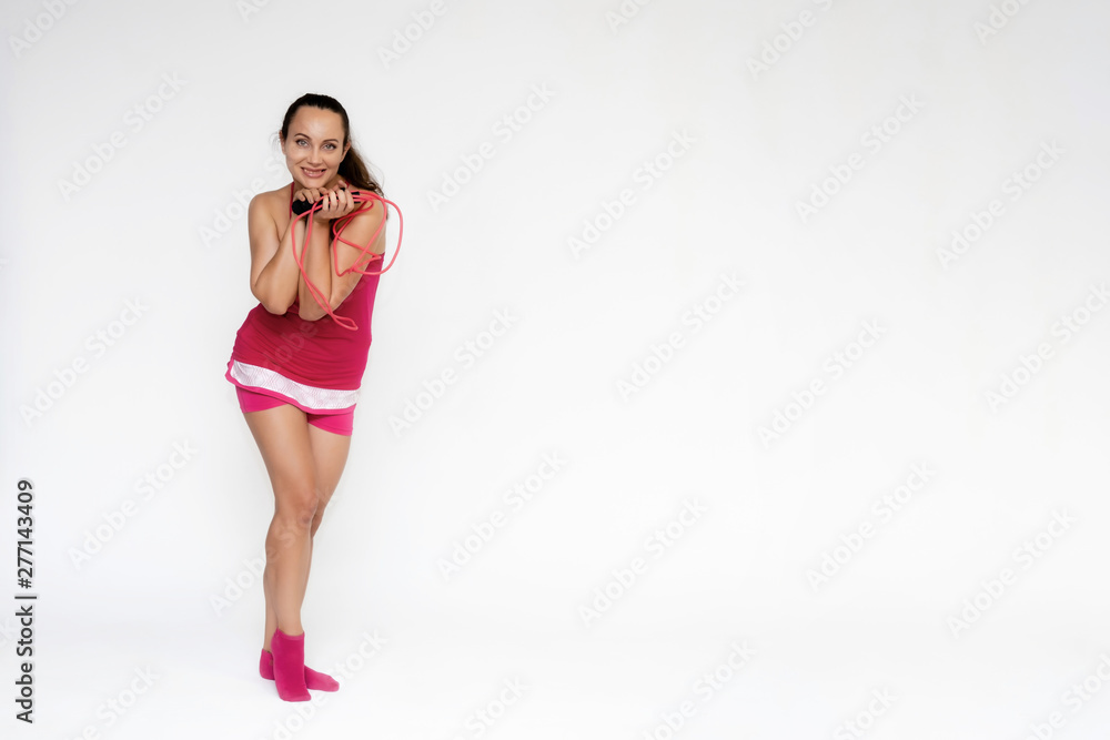 Wall mural full-length portrait on white background of beautiful pretty fitness girl woman in pink sport unifor