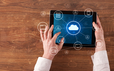 Hand touching tablet with cloud computing and online storage concept