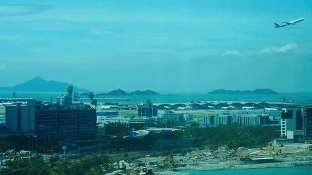 Time lapse of a busy Hong Kong airport with planes landing and going off and moving shadows of clouds