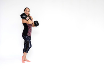 Full-length portrait on white background of beautiful pretty fitness woman girl in fashionable sportswear standing exercising in different poses with boxing gloves. Smiles Stylish trendy youth.