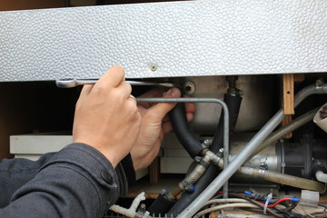 mechanical working on car close up. hands with tool