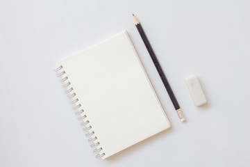Top view of blank notebook with pencil and eraser on with background. Education concept.
