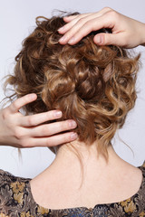 Naklejka premium Portrait of a young ginger woman with wavy hair from back side