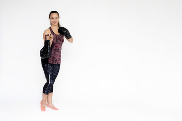 Full-length portrait on white background of beautiful pretty fitness woman girl in fashionable sportswear standing exercising in different poses with boxing gloves. Smiles Stylish trendy youth.