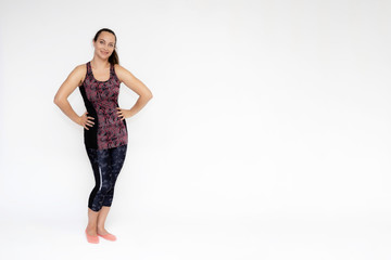 Full-length portrait on white background of beautiful pretty fitness woman girl in fashionable sportswear standing exercising in different poses, showing hands. Smiles Stylish trendy youth.