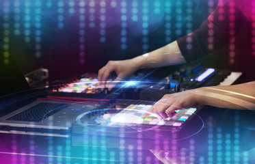 Hand mixing music on dj controller with social media concept icons