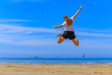 girl jumping on the beach