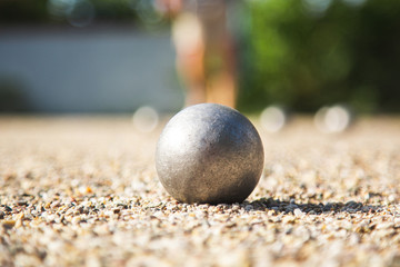 Close up of Bocce ball or Metallic petanque ball on Gravel