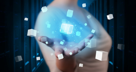 Person holding hologram projection displaying white cubes in server room
