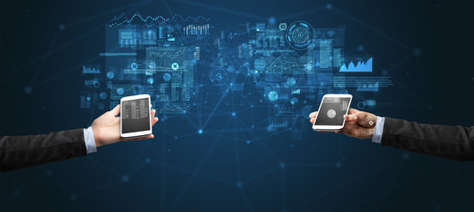 Close up of two hands holding smartphones to sync business data
