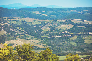 Beautiful landscape, spring nature. View from above of sunny fields on rolling hills in Tuscany, Italy