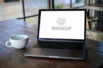 Fototapeta premium Mockup of business man using laptop screen for your advertising text message Laptop with blank screen on table compute work