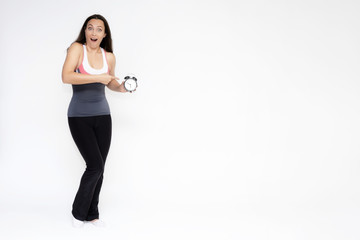 Full-length portrait on white background of beautiful pretty fitness girl woman in sports uniform with a clock in her hands, stands with different emotions in different poses. Stylish trendy youth.