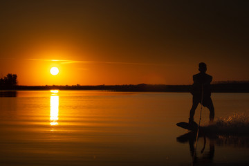 Fototapeta na wymiar wakeboard, athlete silhouette on sunset background