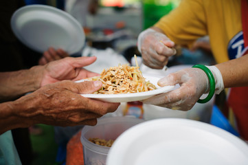 The Concept of Feeding : The poor have been sharing food from the kinder society to Relieve Hunger : Social concept of poor people sharing : Concept serving free food to the poor