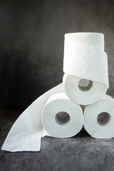 Rolls of toilet paper on a dark background.The Topic Of Hygiene