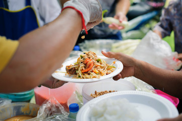 Social concept of poor people sharing : Concept serving free food to the poor : Free food, Using leftovers to feed the hungry : Food concept of hope : The poor are reaching for food