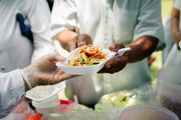 Social concept of poor people sharing : Concept serving free food to the poor : Free food, Using leftovers to feed the hungry : Food concept of hope : The poor are reaching for food