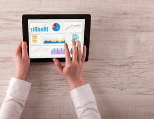 Hand making diagrams and charts on tablet