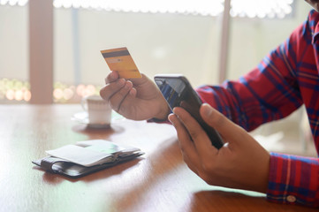 Man use smart phone and hold credit card with shopping online. Online shopping concept. 