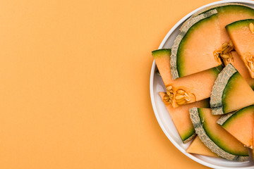 Sliced Cantaloupe Melon Served on Plate, Pastel Background , Border Background - obrazy, fototapety, plakaty