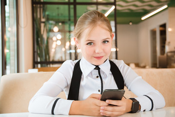 Charismatic girl as a businesswoman in cafe at lunch. Business youth.