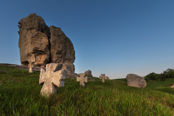 Large stonemasons on the background of endless fields and forests in the evening with beautiful sky...