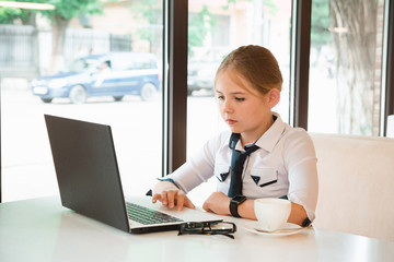 Charismatic girl as a businesswoman in cafe at lunch. Business youth.