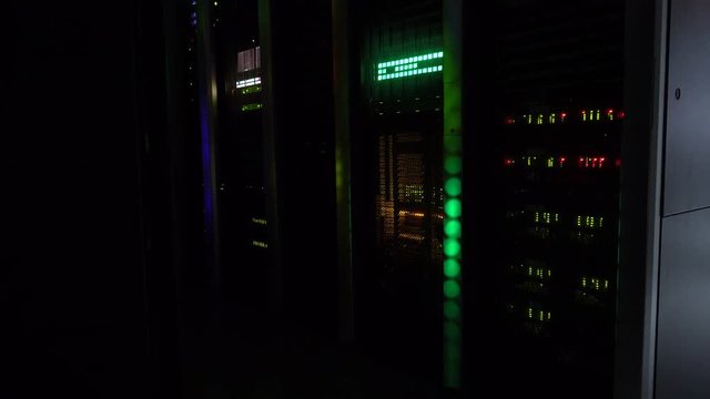 In the dark. A working supercomputer. Server room. video contains noise and fliker.