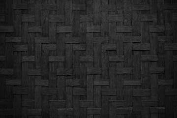 Black woven wood texture background.Dark weave bamboo wood texture