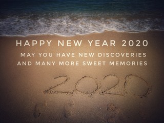 Fototapeta premium New Year Quote On Blurred Sandy Beach Background