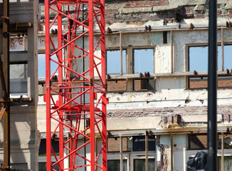 Red crane at demolition site at Government street