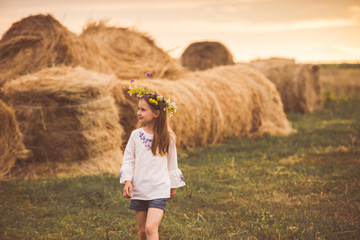 Kid girl having a walk in the village