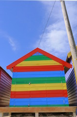 front view of colorful striped bathing house, brighton beach, melbourne, australia
